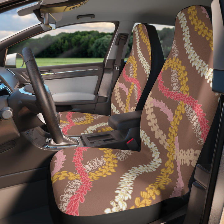 the interior of a car with a colorful Hawaiian flower lei floral patterned on 2 front seat covers