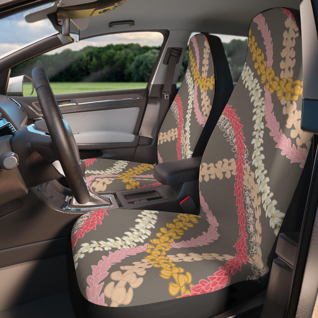 the interior of a car with a colorful floral Hawaiian flower lei patterned front seat covers.