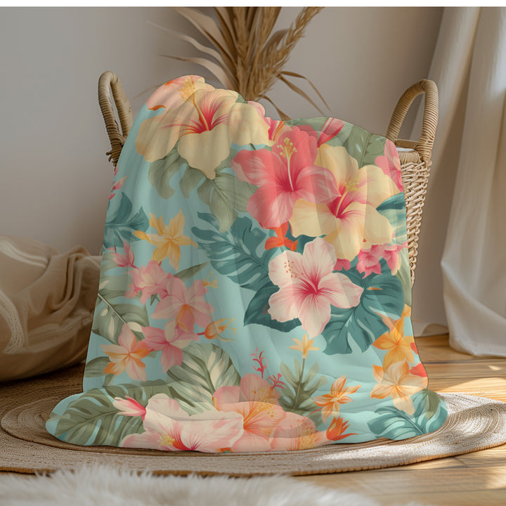 a large bed covered in a colorful Hawaiian floral comforter.