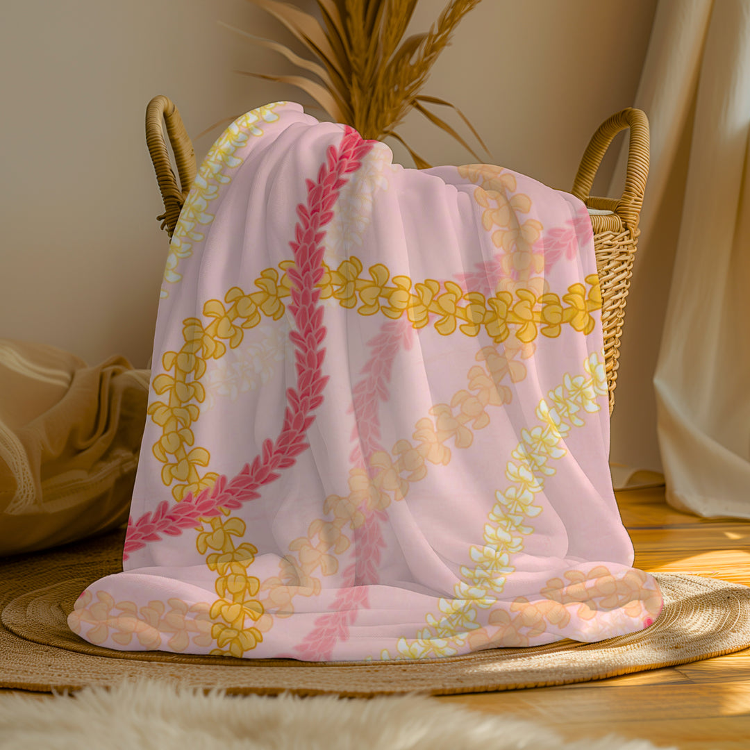 a pink and yellow Hawaiian flower lei floral print blanket