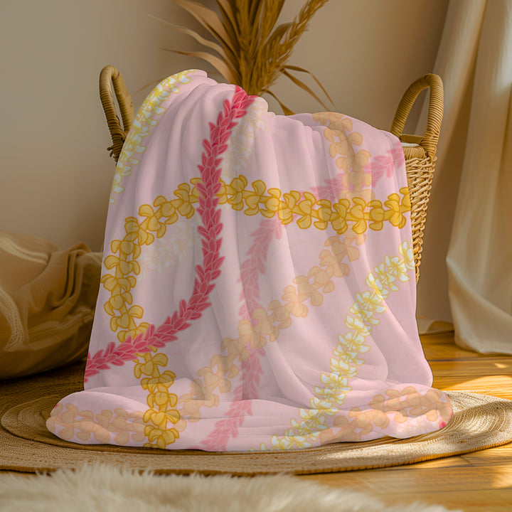 a pink and yellow Hawaiian flower lei floral print blanket
