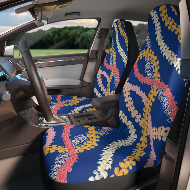 a car with colorful flower lei patterned front seat covers in shades of blue, red, and yellow.
