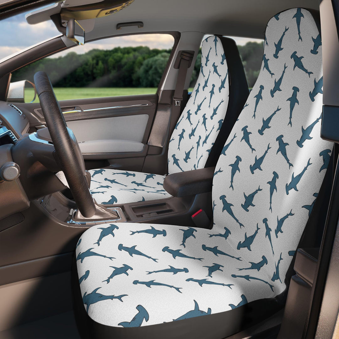 the interior of a car with a patterned front car seat cover featuring a repeating design of hammerhead sharks.