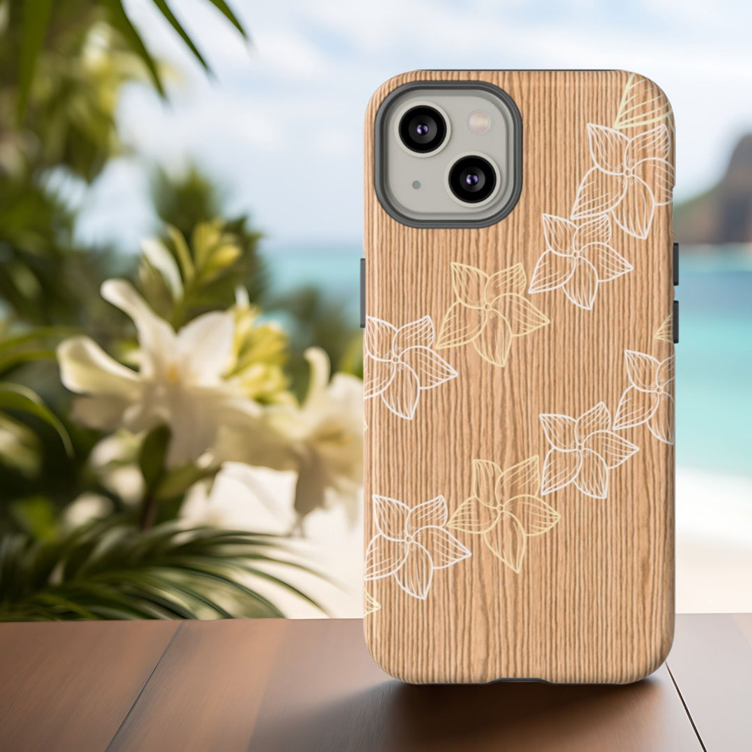 A wooden phone case with a floral design is placed on an abstract wooden surface