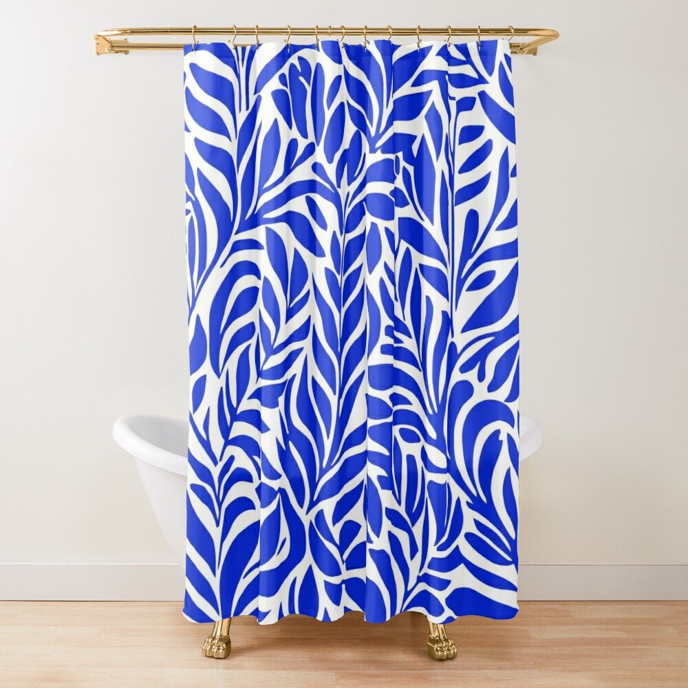A blue and white patterned shower curtain with a leaf design