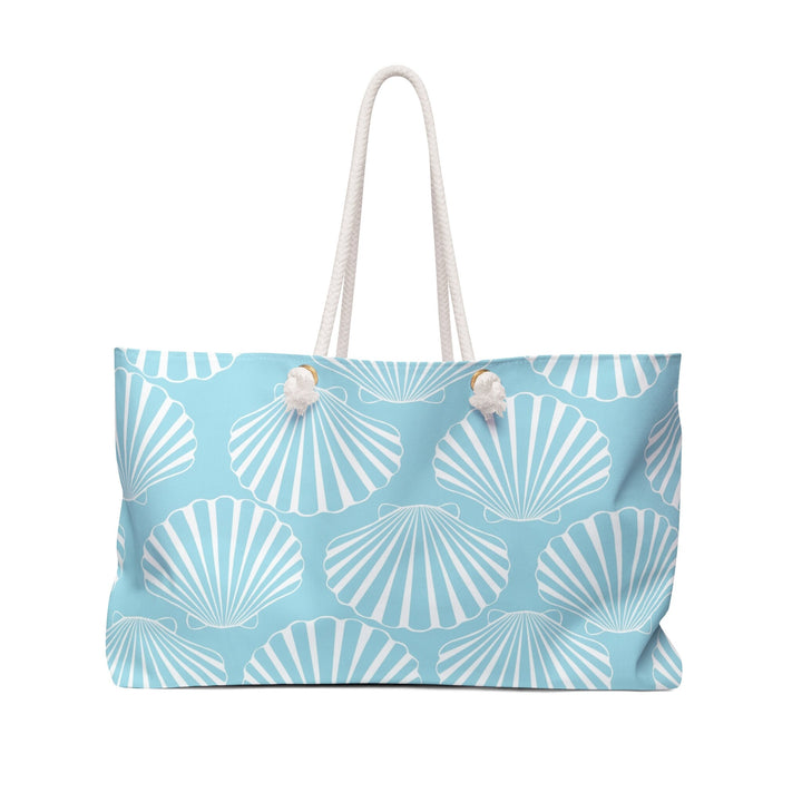 A blue tote bag with a white shell pattern printed on it