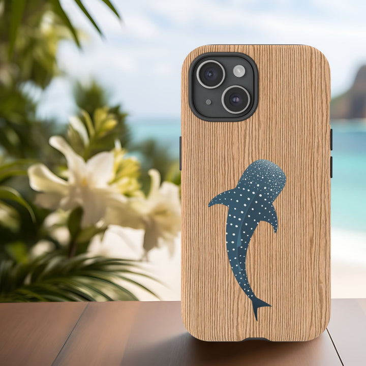 an abstract wooden phone case with a blue whale silhouette on it