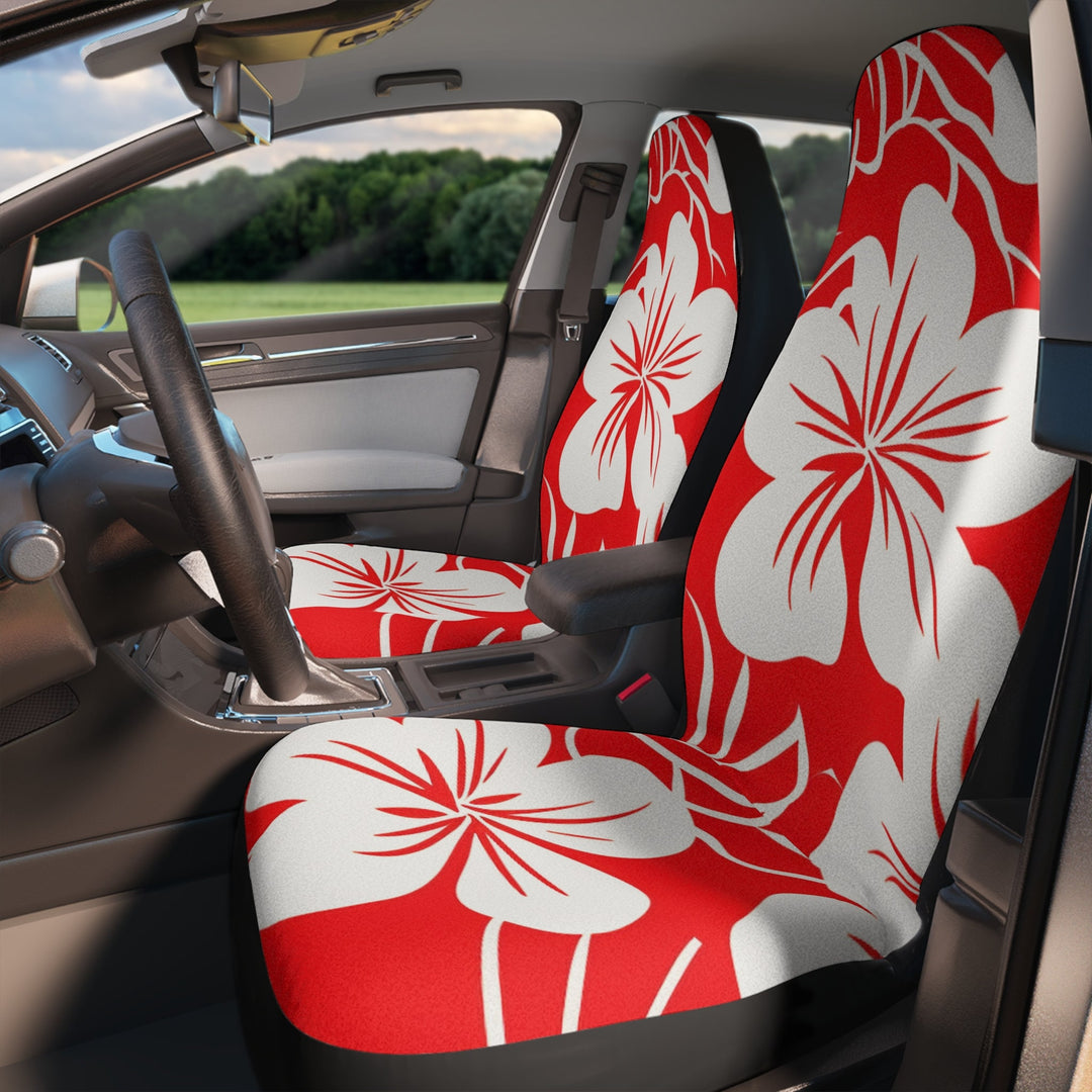 the interior of a car with 2 front seat hibiscus floral patterned seat cover in red and white colors.