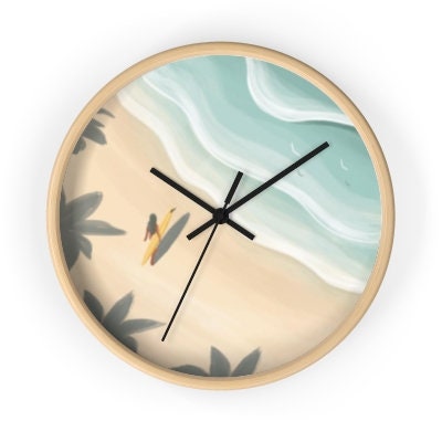 A round wall clock with a beach scene depicted on its face, featuring a surfer and palm trees.