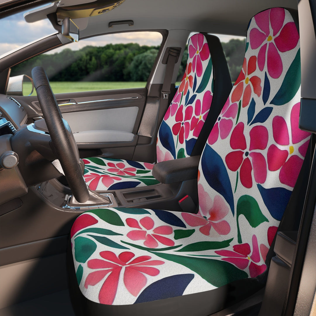 the interior of a car with an abstract floral patterned seat cover on the driver's seat and a passenger seat cover on the passenger seat.