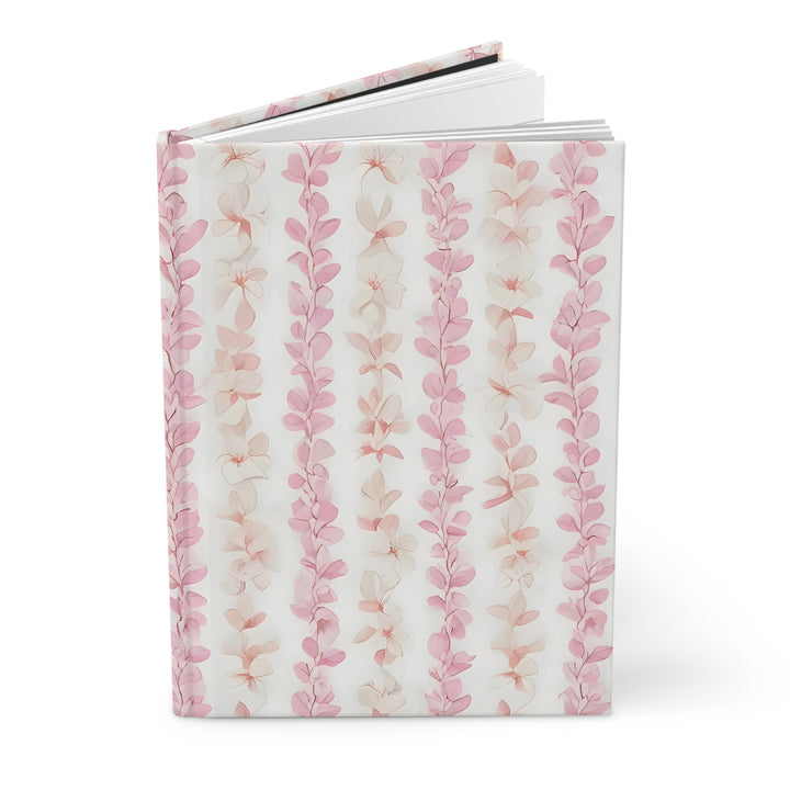 a book with a floral pattern on the cover, which appears to be a white book with pink and white floral designs.
