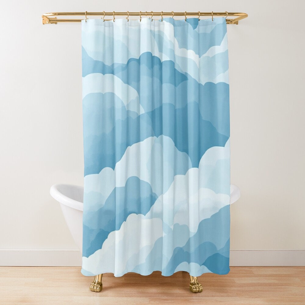 A shower curtain with a blue and white cloud pattern.