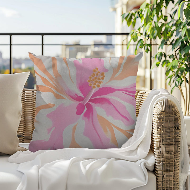 a large, colorful floral pillow featuring an abstract pink and white hibiscus