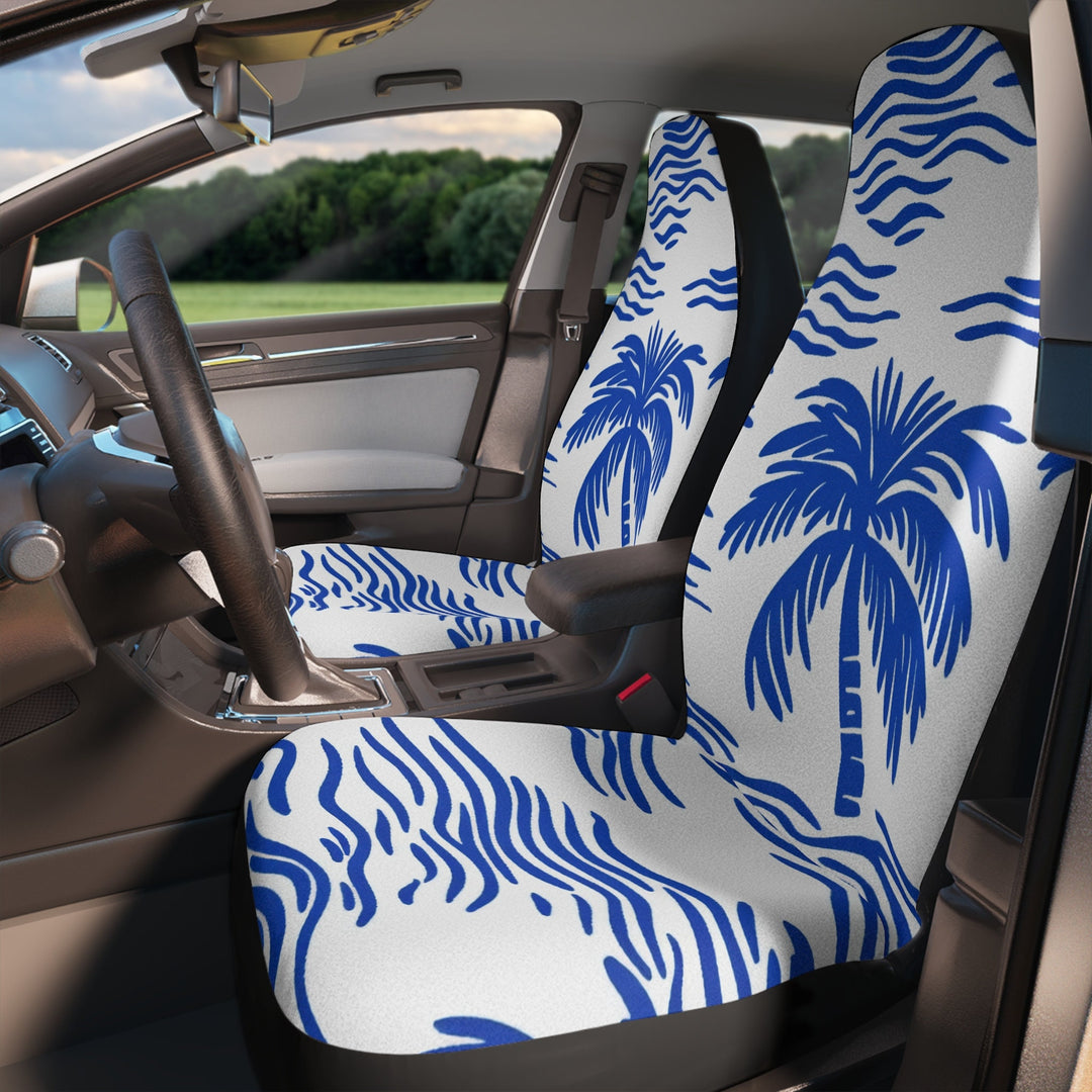 the interior of a car with a patterned seat cover featuring a blue and white design of palm trees.